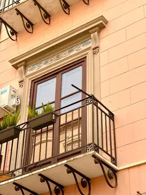 a kitchen with a white table and a chandelier at Kalsa Baroque Apartment in Palermo