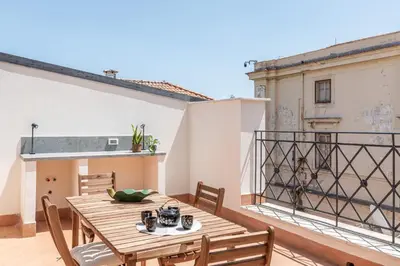 a kitchen with a white island in the middle of a room at Oretea Apartment with Terrace by Wonderful Italy in Palermo