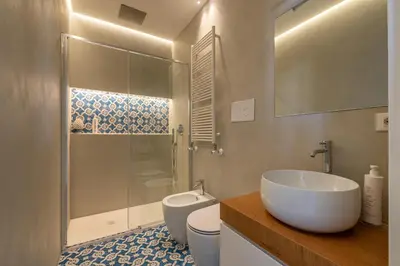 a bedroom with a bed and a desk in a room at Oretea Apartment with Terrace by Wonderful Italy in Palermo
