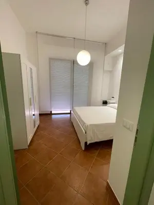 a bedroom with a bed and a large mirror at Vittorosa House in Palermo