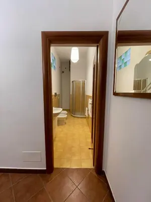 a bathroom with a toilet and a sink at Vittorosa House in Palermo