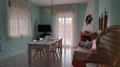 a living room with a table and a couch at Villa Alba in Mandra Capreria