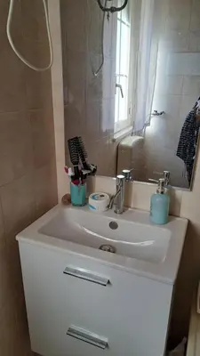 a bathroom with a white sink and a mirror at Villa Alba in Mandra Capreria