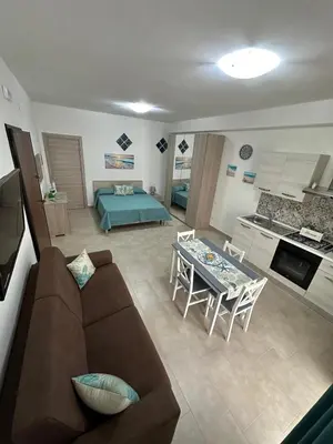 a living room with a couch and a table at Sogno d'estate in Isola delle Femmine
