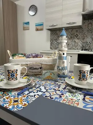 a kitchen counter with two cups and plates on it at Sogno d'estate in Isola delle Femmine