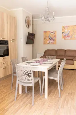 a white dining room table and chairs in a room at Oltre il Mare Trabia in Trabia