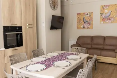 a dining room table with chairs and a couch at Oltre il Mare Trabia in Trabia