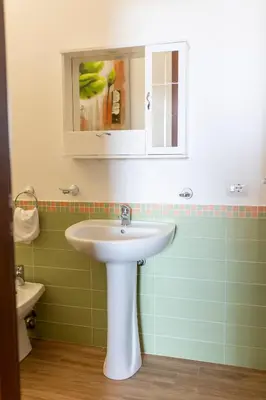 a bathroom with a sink and a mirror at Oltre il Mare Trabia in Trabia