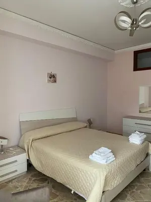a bedroom with a bed and a dresser and a mirror at Casa vacanze anto antonella in Bagheria