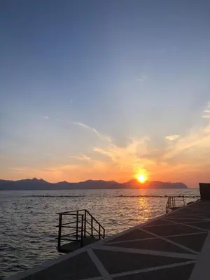 a sunset over a body of water with a pier at Casa vacanze anto antonella in Bagheria