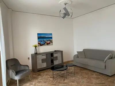 a living room with a couch and a chair at Casa vacanze anto antonella in Bagheria