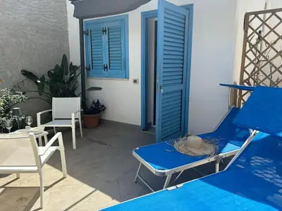 a patio with a blue chair and a blue door at Residenza Saturno 7 in Palermo