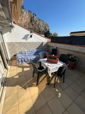 a patio with a table and chairs on a balcony at Casa delle Stelle in Mondello