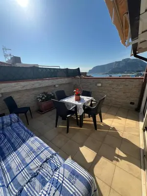 a patio with a table and chairs on a roof at Casa delle Stelle in Mondello