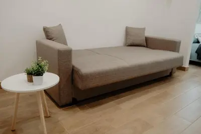a couch and a table in a living room at Barù home in centro in Palermo