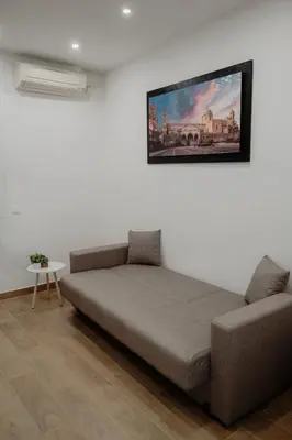 a bed in a room with a picture on the wall at Barù home in centro in Palermo