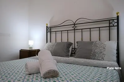 a bed with a towel laying on top of it at Appartamenti Esther in San Vito lo Capo