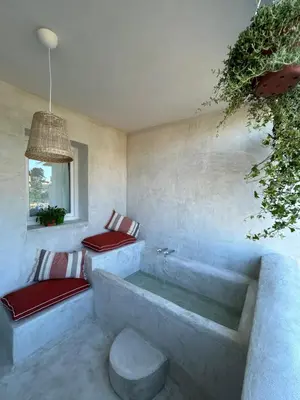 a bathroom with two benches and a bath tub at Palazzo Crisafulli 1- casa Liberty con vasca esterna in Palermo