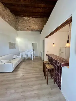 a living room with a white couch and a table at Palazzo Crisafulli 1- casa Liberty con vasca esterna in Palermo