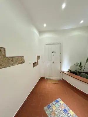 an empty room with a staircase and a rug at Palazzo Crisafulli 1- casa Liberty con vasca esterna in Palermo