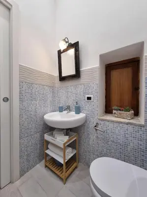 a bathroom with a sink and a toilet at Il Mio Canto Home in Palermo