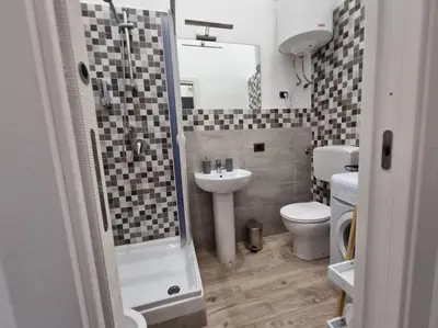 a bathroom with a shower and a sink and a toilet at Il Mio Canto Home in Palermo