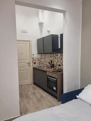 a small kitchen with a sink and a stove at Il Mio Canto Home in Palermo