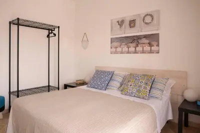a bedroom with a bed with two pillows on it at Cefalù, Lascari - Appartamento moderno vicino al mare in Lascari