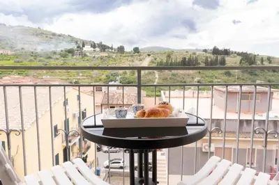 a table with a tray of food on a balcony at Cefalù, Lascari - Appartamento moderno vicino al mare in Lascari