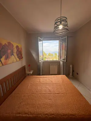 a bedroom with a large bed and a window at Anna&Micky town house in Santa Flavia