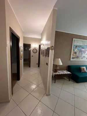 a hallway with a living room with a couch and a table at Anna&Micky town house in Santa Flavia
