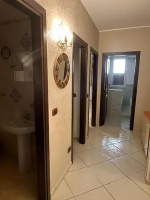 a bathroom with a sink and a toilet and a mirror at Anna&Micky town house in Santa Flavia