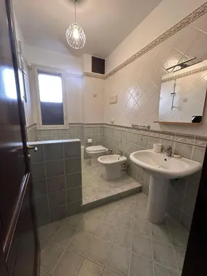 a bathroom with a sink and a toilet at Anna&Micky town house in Santa Flavia