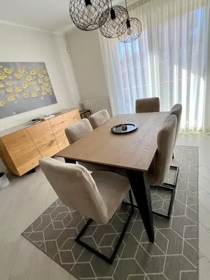 a dining room table and chairs in a living room at NOVIMO Comfort Apartment with elevator & secure privat parking in Terrasini