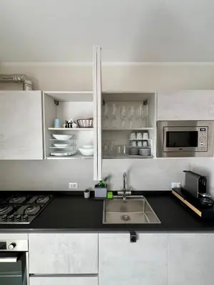a kitchen with a sink and a microwave at NOVIMO Comfort Apartment with elevator & secure privat parking in Terrasini