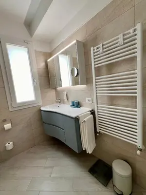 a bathroom with a sink and a mirror at NOVIMO Comfort Apartment with elevator & secure privat parking in Terrasini