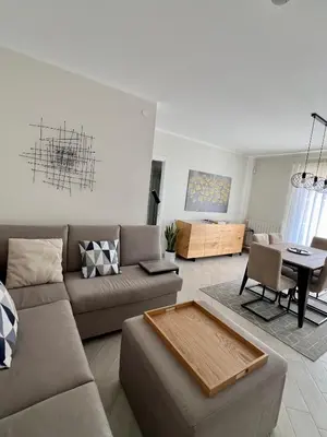 a living room with a couch and a table at NOVIMO Comfort Apartment with elevator & secure privat parking in Terrasini