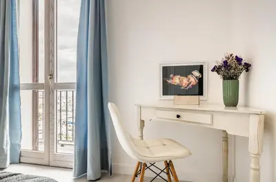 a white desk with a chair next to a window at GuestHost - La Cala Sea View Apartment with Balconies in Palermo