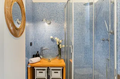 a bathroom with a sink and a shower with a mirror at GuestHost - La Cala Sea View Apartment with Balconies in Palermo