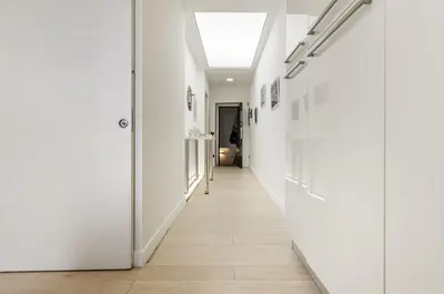a hallway with white walls and a skylight at GuestHost - La Cala Sea View Apartment with Balconies in Palermo