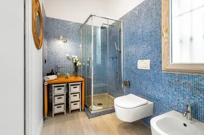 a bathroom with a shower and a toilet and a sink at GuestHost - La Cala Sea View Apartment with Balconies in Palermo