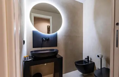 a bathroom with a black sink and a mirror at Amari120Suite&Spa in Palermo