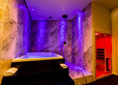 a bathroom with a tub with purple lighting at Amari120Suite&Spa in Palermo