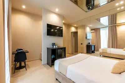 a bedroom with a bed and a table and a television at Amari120Suite&Spa in Palermo