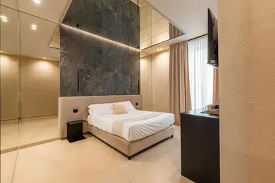 a bedroom with a bed and a black wall at Amari120Suite&Spa in Palermo