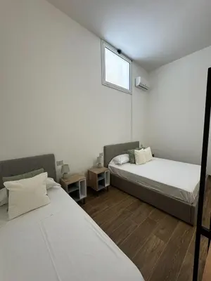 a bedroom with two beds and a window at Casa Bedda - INTERA CASA CON 3 CAMERE CON BAGNO PRIVATO, ARIA CONDIZIONATA E NO ZTL/ENTIRE APARTMENT WITH 3 BEDROOMS WITH PRIVATE BATHROOM, AIRCON AND NO LTZ in Castellammare del Golfo