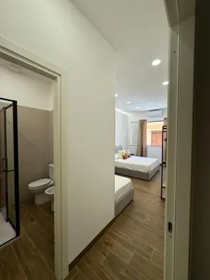 a bedroom with a bed and a toilet in a room at Casa Bedda - INTERA CASA CON 3 CAMERE CON BAGNO PRIVATO, ARIA CONDIZIONATA E NO ZTL/ENTIRE APARTMENT WITH 3 BEDROOMS WITH PRIVATE BATHROOM, AIRCON AND NO LTZ in Castellammare del Golfo