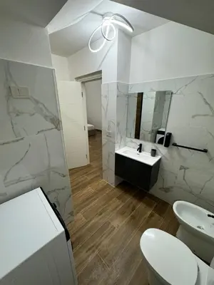 a bathroom with a sink and a toilet and a mirror at Casa Bedda - INTERA CASA CON 3 CAMERE CON BAGNO PRIVATO, ARIA CONDIZIONATA E NO ZTL/ENTIRE APARTMENT WITH 3 BEDROOMS WITH PRIVATE BATHROOM, AIRCON AND NO LTZ in Castellammare del Golfo