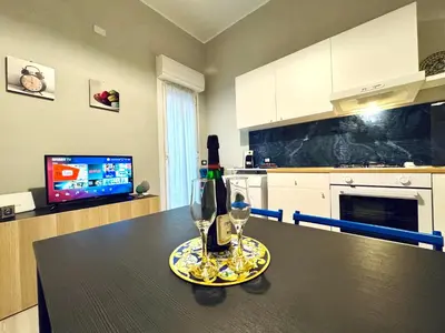 a kitchen with a table with two wine glasses on it at Angelia in Capaci
