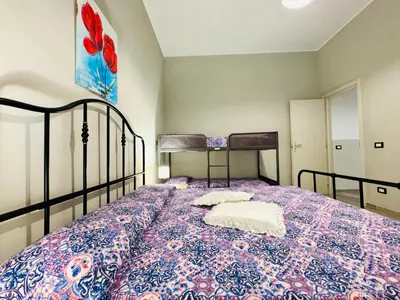 a bedroom with a bed with a blue and white bedspread at Angelia in Capaci